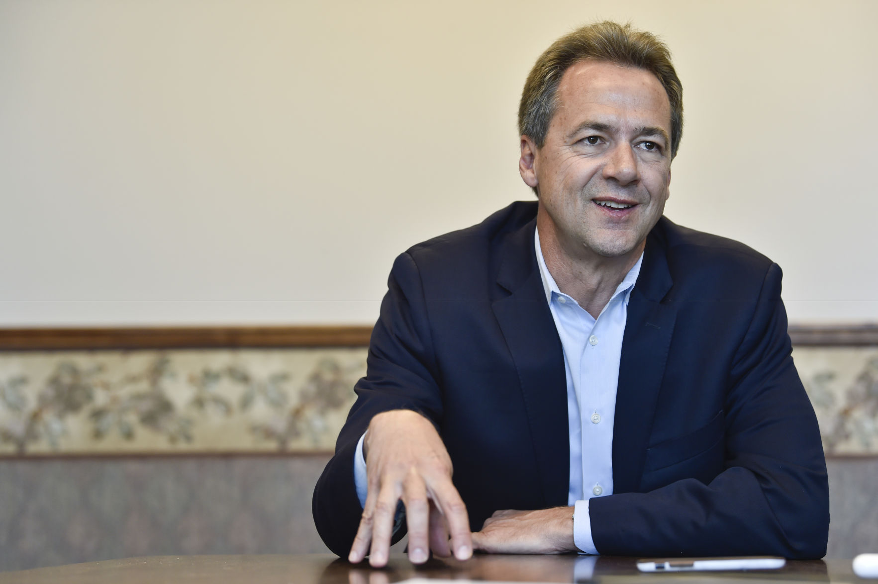 Gov. Steve Bullock talks with a reporter